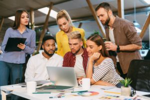 Freelance web designers brainstorming together in office