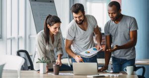 Website header of Business people standing over laptop at table in office